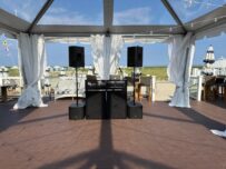 IMG_0013 A large tent with speakers and curtains on the roof.