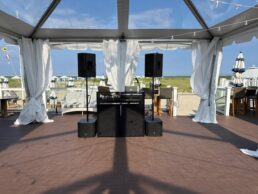 IMG_0013 A large tent with speakers and curtains on the roof.